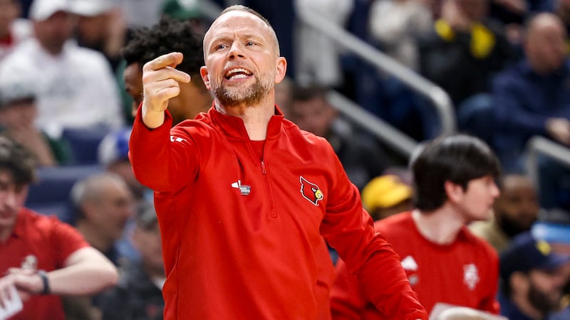 Louisville coach Pat Kelsey shouts to his team during an NCAA Tournament game against Michigan...