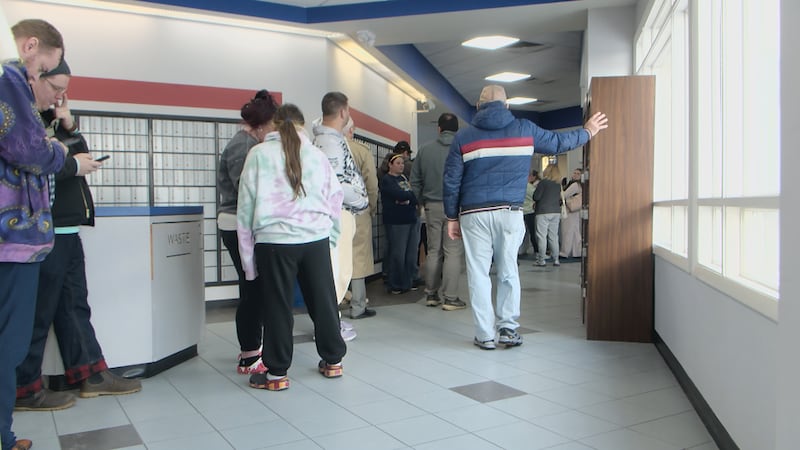 Residents line up at the PRP neighborhood post office as delivery delays continue two weeks...