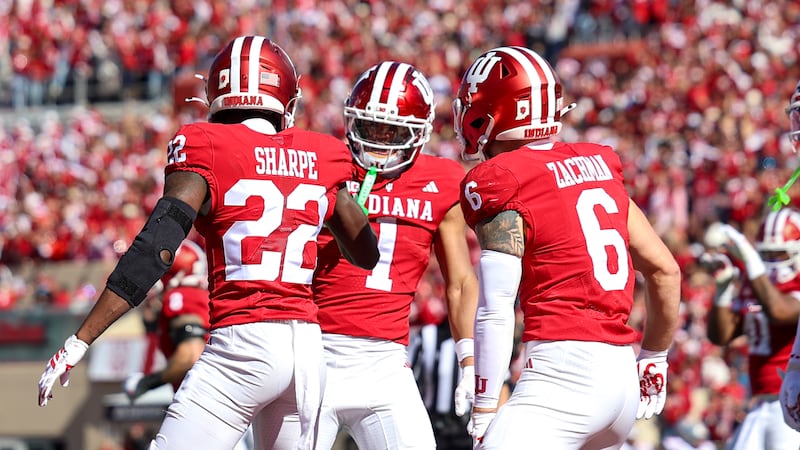 Indiana's Jamari Sharpe, Amare Ferrell and Preston Bachman celebrate an interception in the...