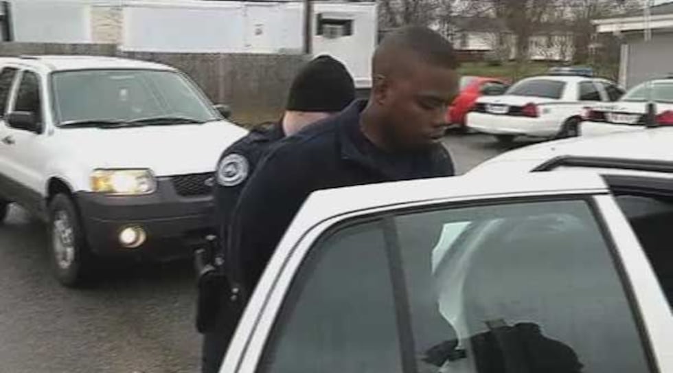 Jacobs being put into a Portland, TN police car.