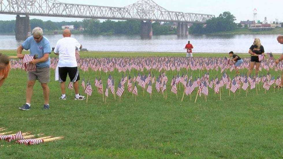 Volunteers said they participate in the flag planting to show those who serve how much they're...