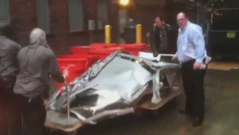 Wreckage of the Brown Hotel air conditioning unit being removed after it fell from the roof of...