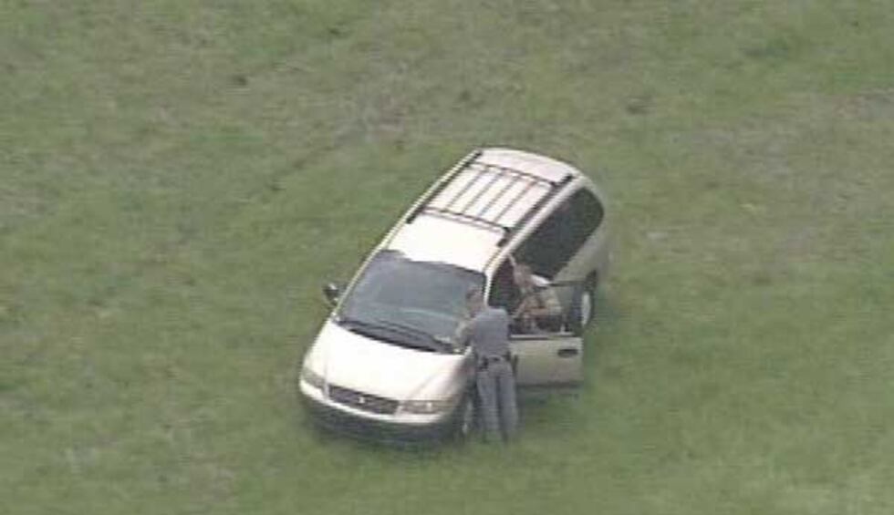 Police search the minivan.