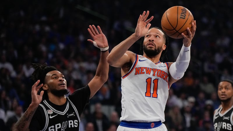 New York Knicks guard Jalen Brunson (11) shoots past San Antonio Spurs guard Stephon Castle...