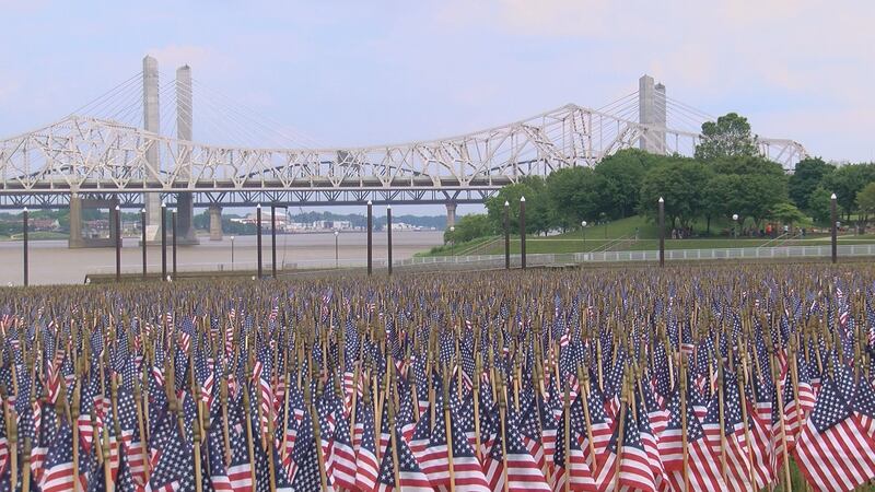 Volunteers started setting up the flags around noon on Saturday, organizing them to spell out...