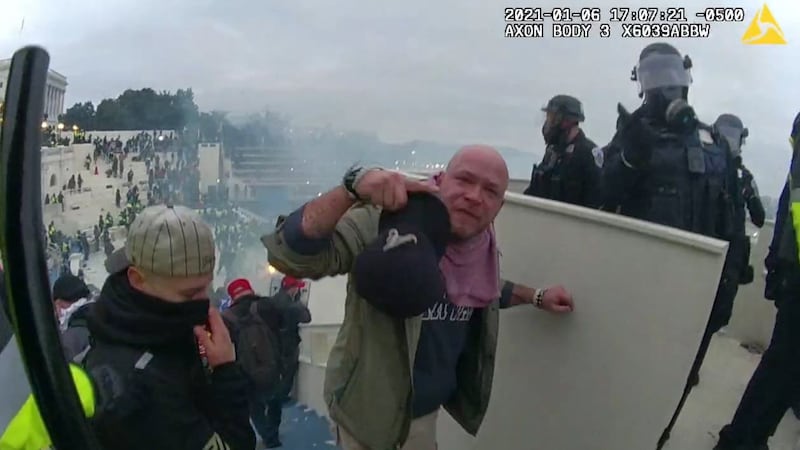 This image from video provided by the Department of Justice from police-worm body camera shows...