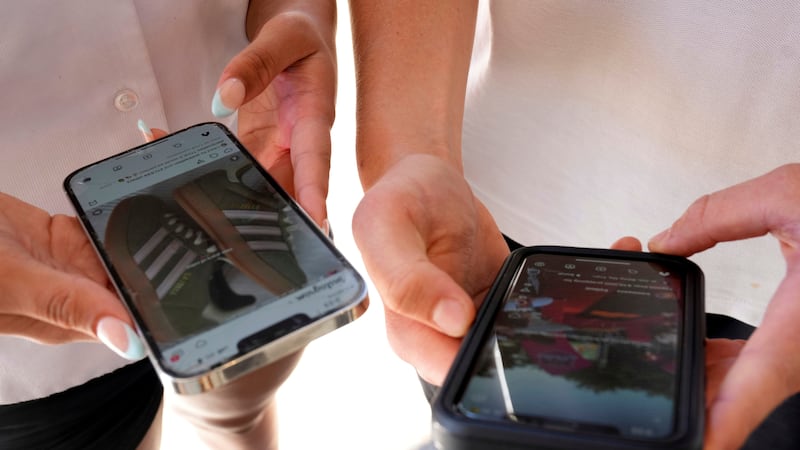 FILE - Young people use their phones to view social media in Sydney, Nov. 8, 2024. (AP...