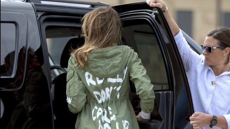 Mrs. Trump's jacket was military green with graffiti-style print which read 'I don't really...