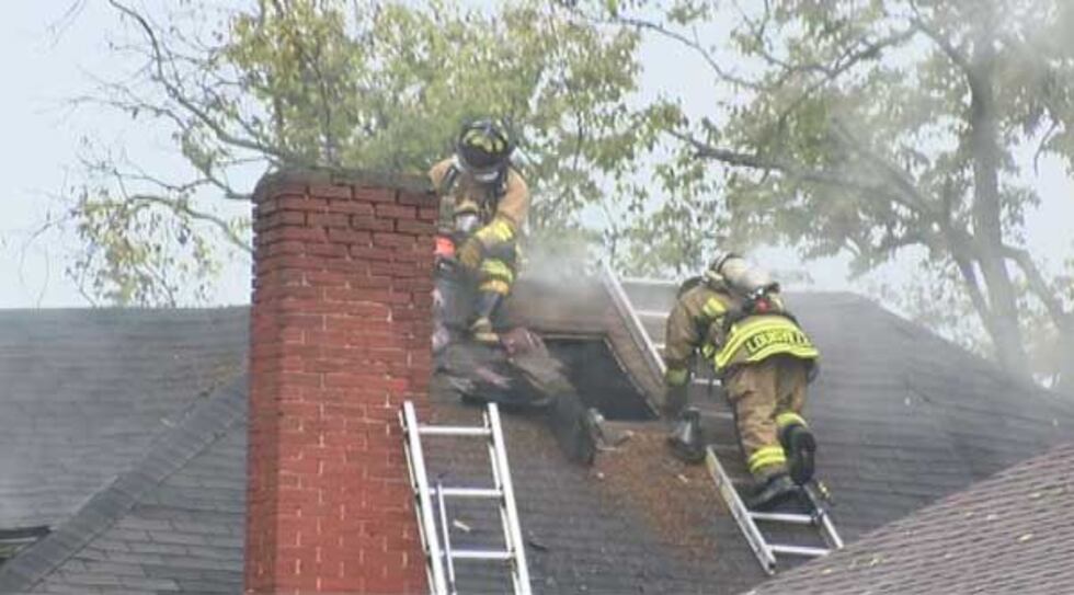 Louisville firefighters ventilate the roof of the building. (Source: Jeff Knight, WAVE 3 News)