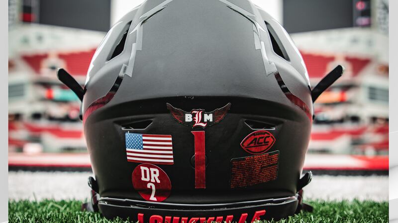 The University of Louisville football program have added decals to their helmets honoring a...