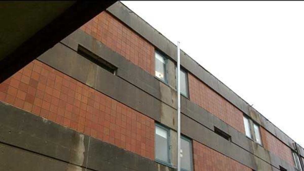 Downspout left hanging free after guttering was stolen from Fairdale High School.