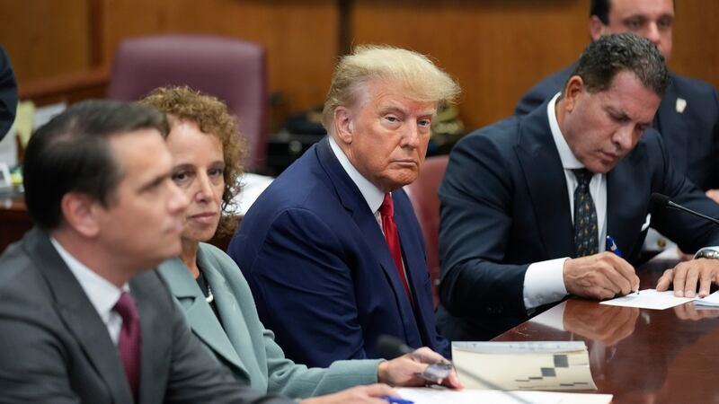 FILE - Former President Donald Trump sits at the defense table with his legal team in a...