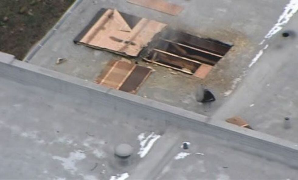 Smoke coming from a hole in the roof of the complex.